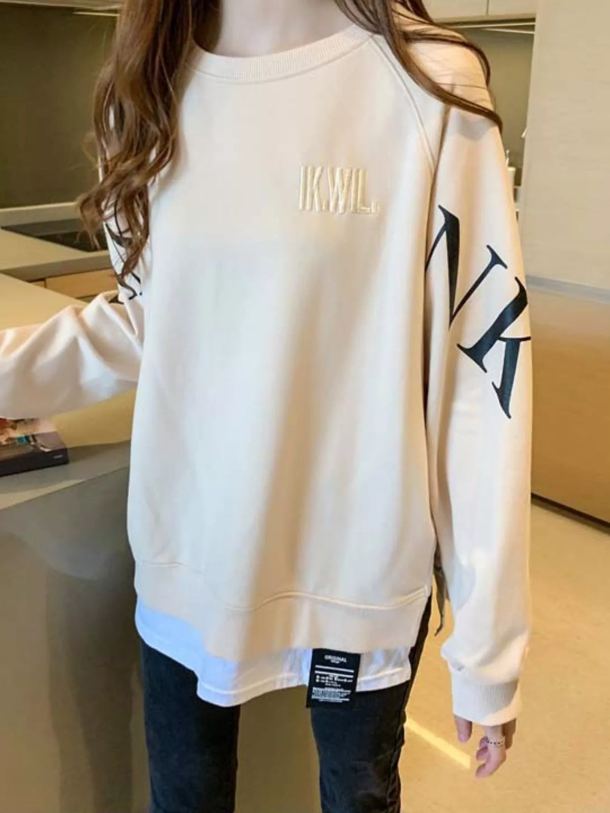 Apricot layered-hem sweatshirt with graphic sleeve detail