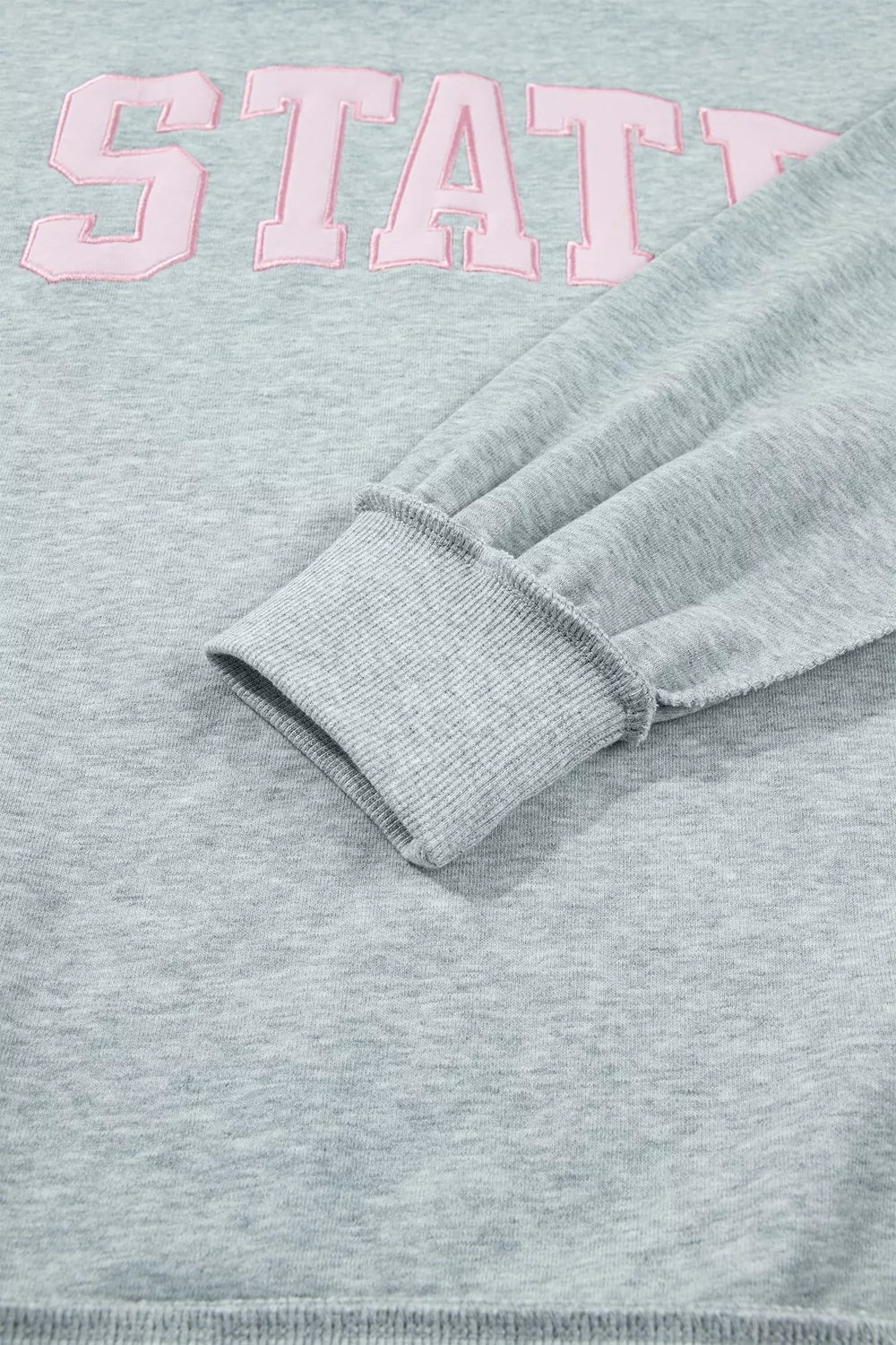 STATE Graphic Exposed Seam Mock Neck Sweatshirt in gray, cuff and lettering detail