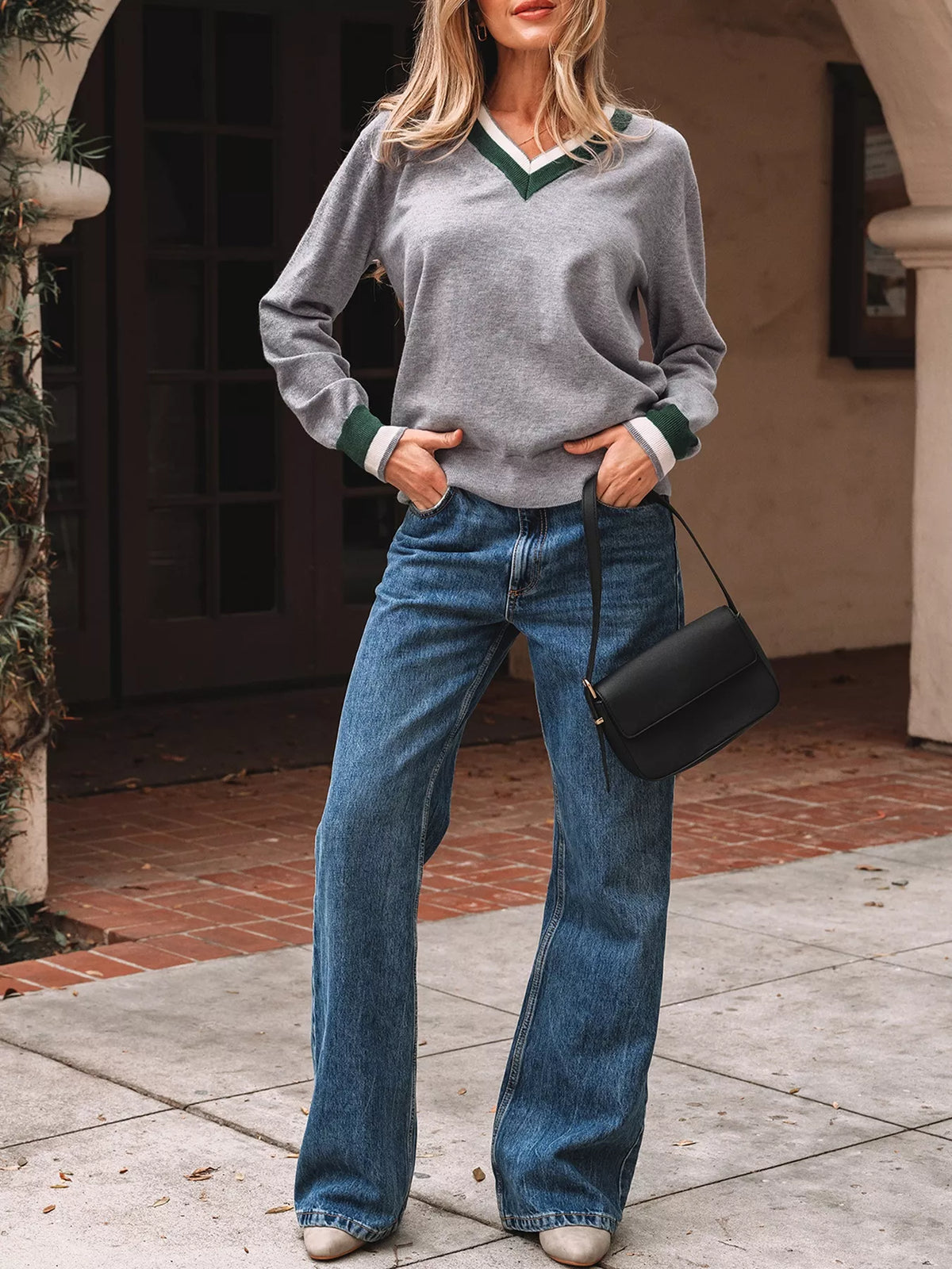 Gray v-neck sweater with striped trim, full-length styled view.