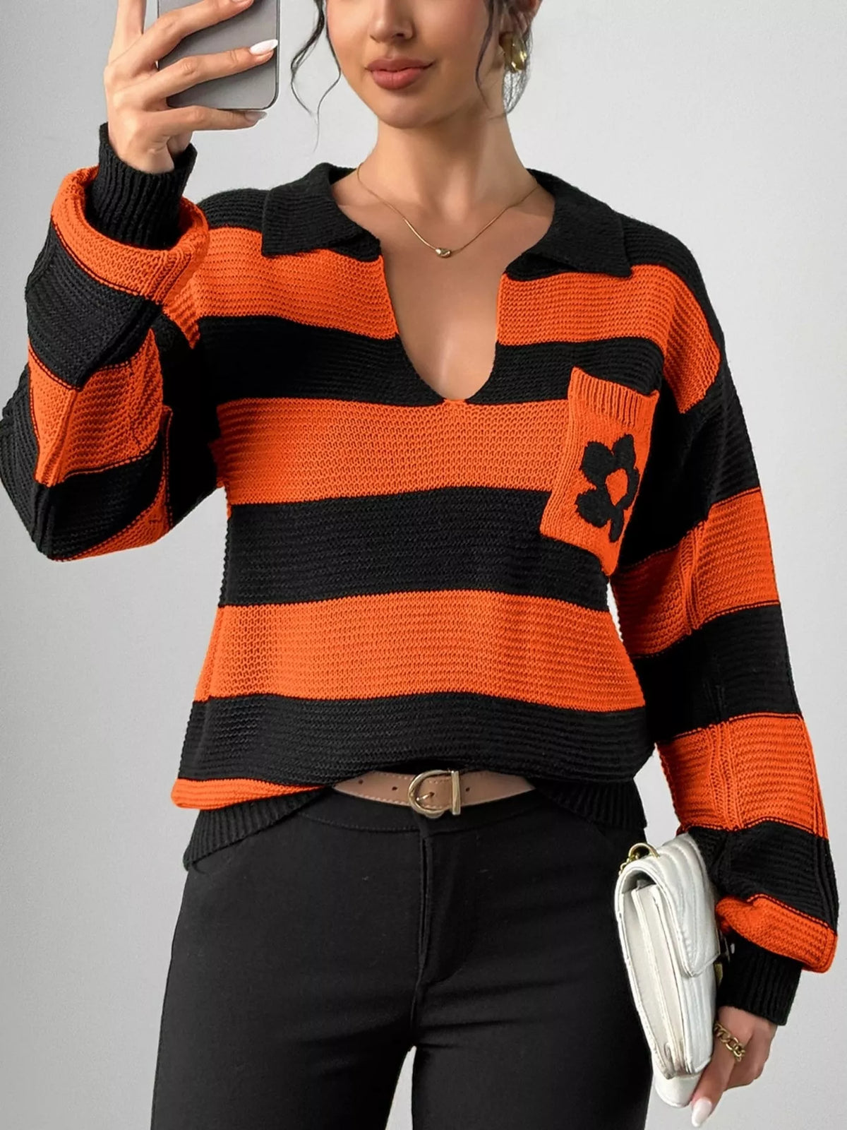 Orange striped polo collar sweater with floral pocket detail