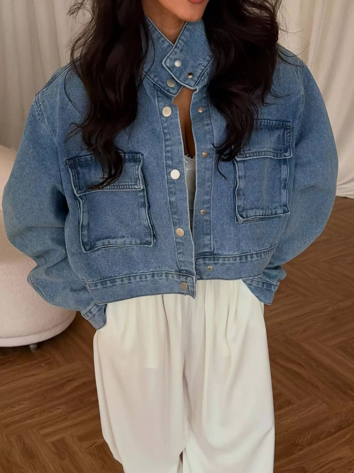Blue oversized cropped denim utility jacket, front view fastened at collar.