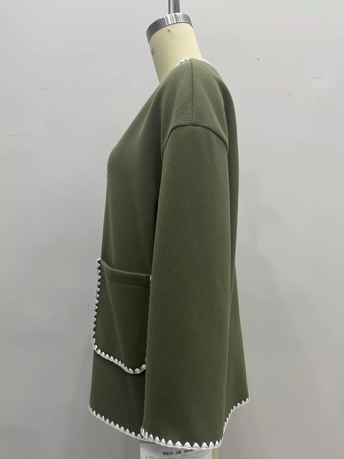 Olive green contrast trim button-front jacket, side view