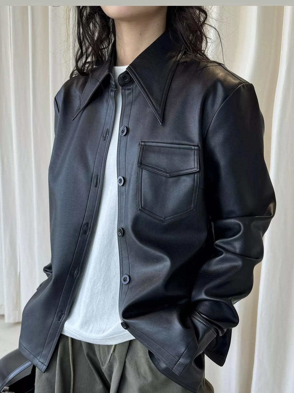 Black faux leather button-front jacket — front view
