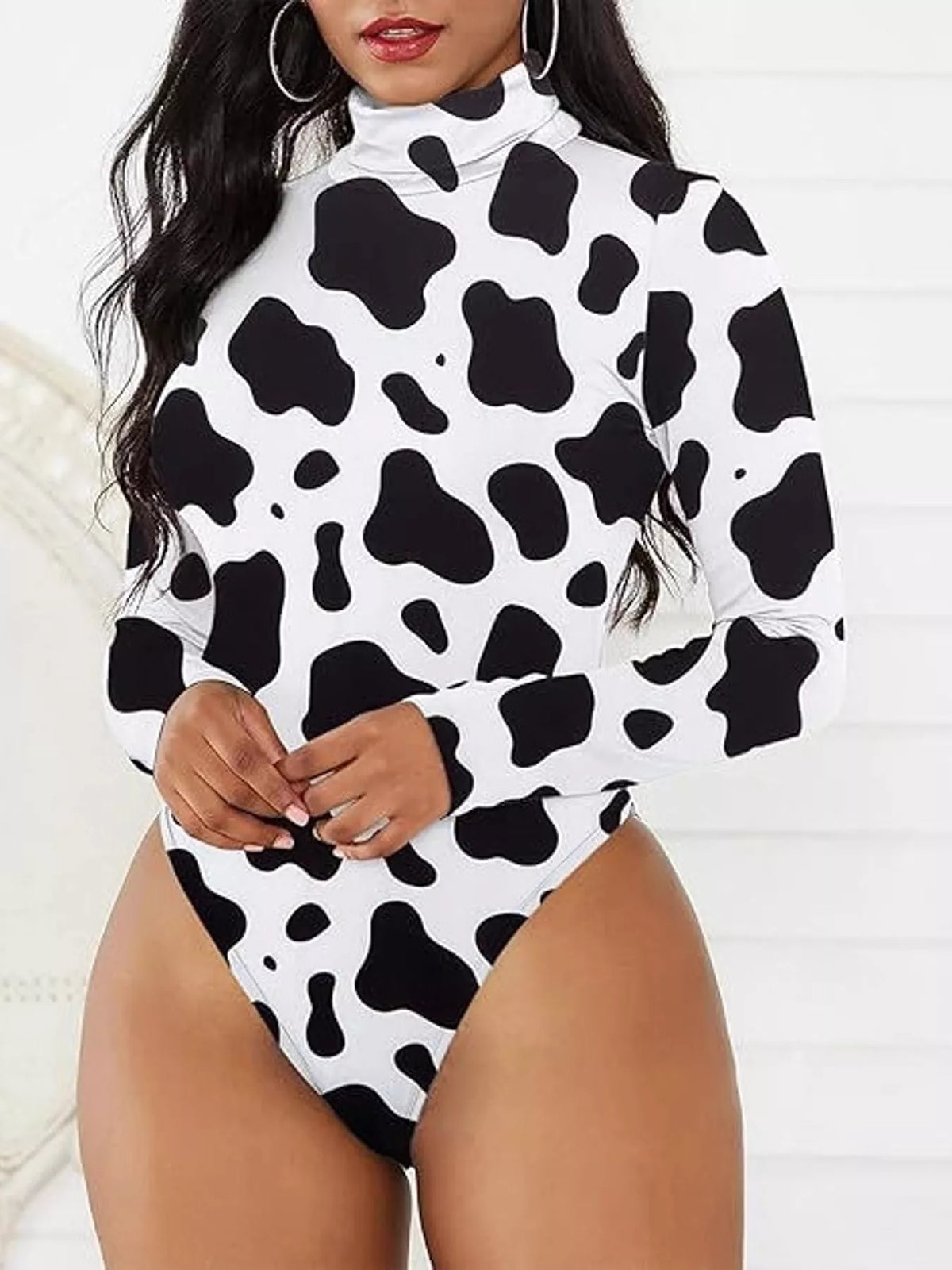 Long Sleeve Turtleneck Slim-Fit Bodysuit in black and white cow print