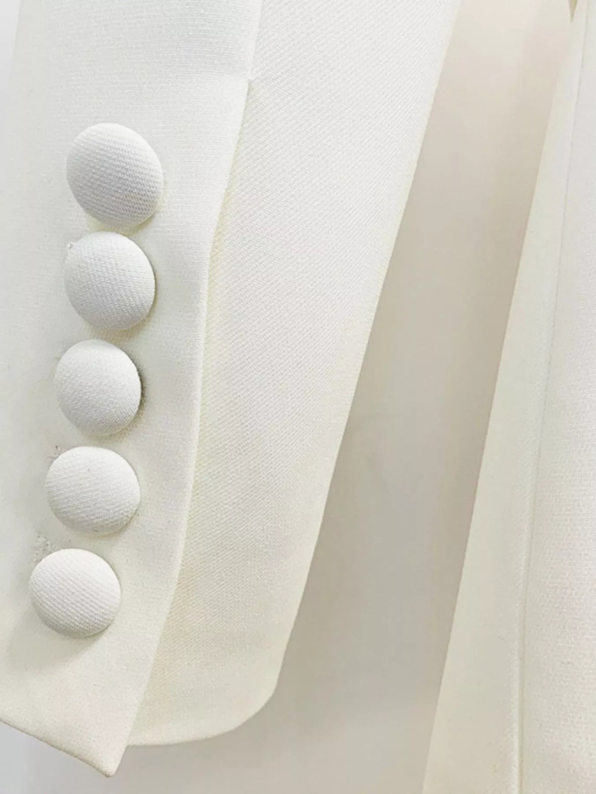 White one-button blazer and flared pants set, detail view