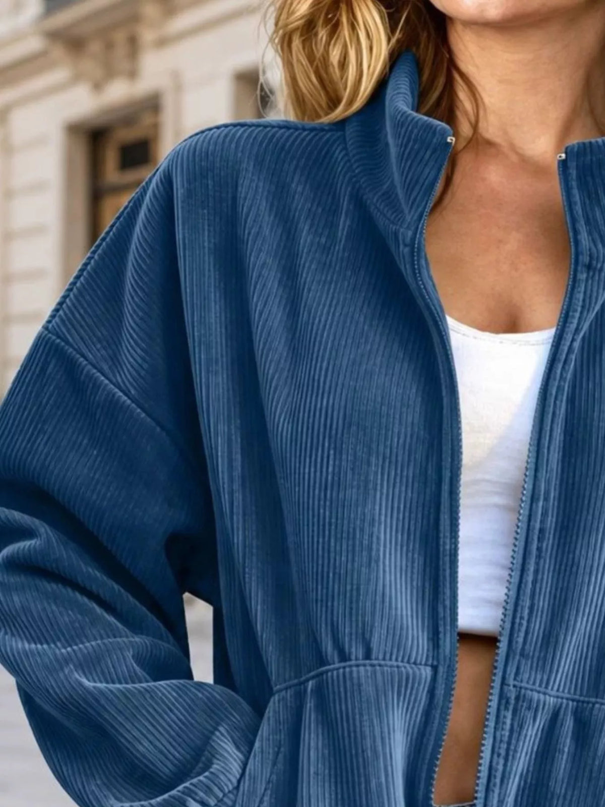 Blue corduroy zip-up jacket, collar and zipper detail