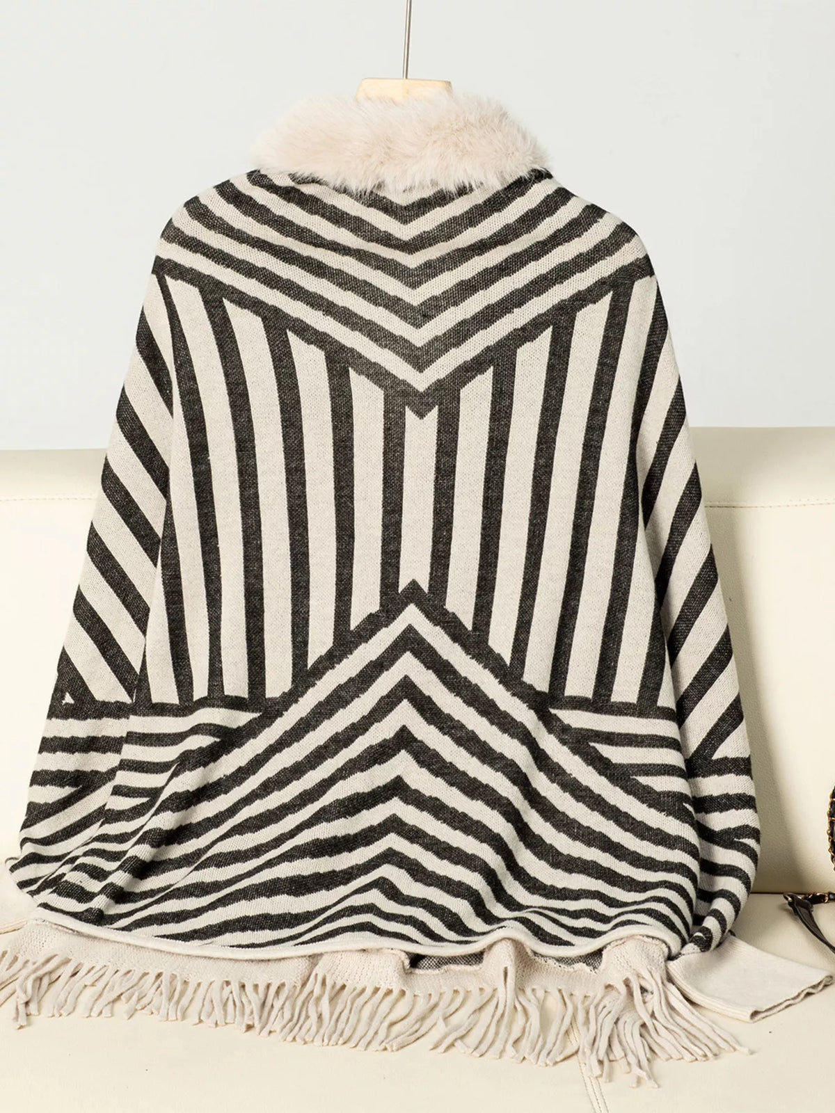 Faux Fur Trimmed Striped Knit Fringe Poncho, back view in cream and black