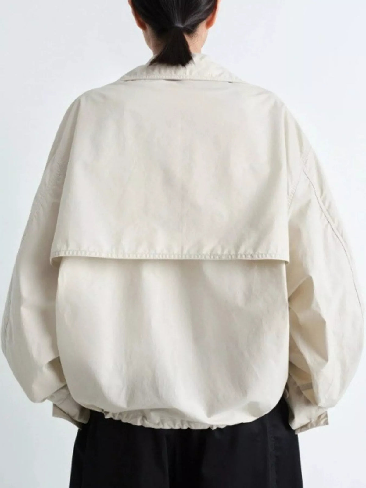Cream double-breasted utility jacket with drawstring hem — back view