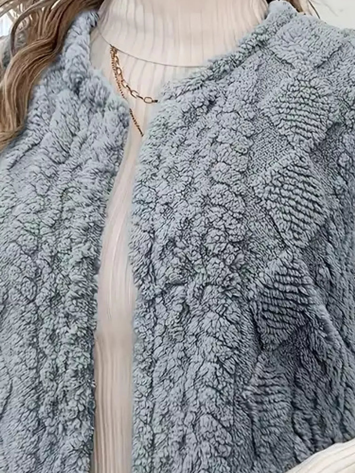 Blue-gray sherpa open front vest coat, open neckline and raised textured panels