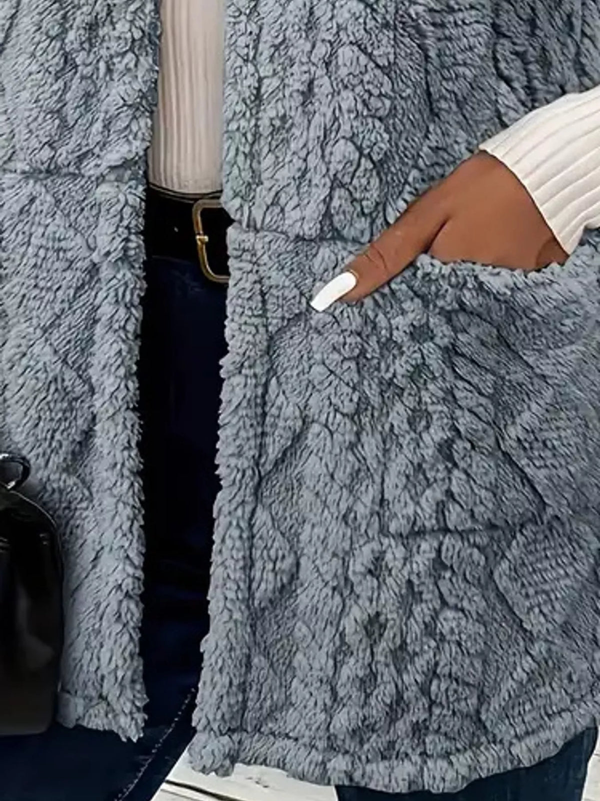 Blue-gray sherpa open front vest coat, close-up of patch pocket and textured panels
