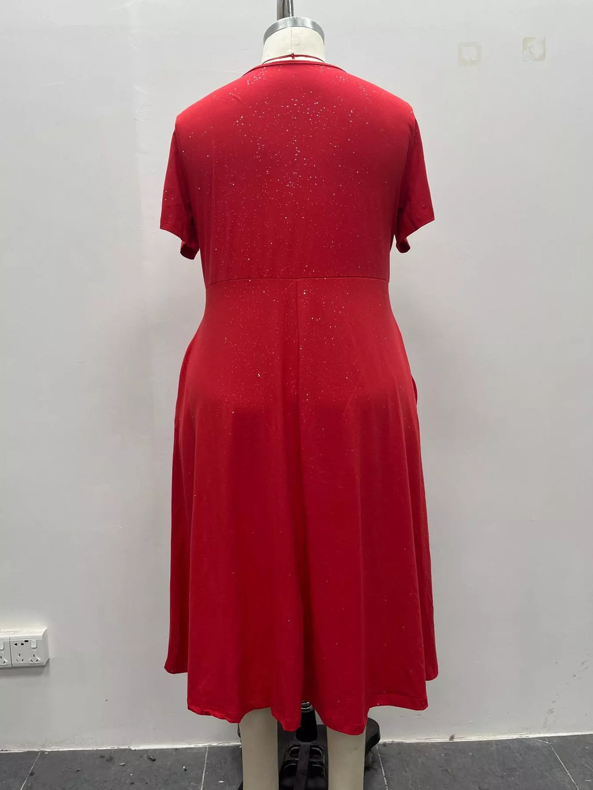 Red speckled short sleeve midi dress with pockets, back on mannequin