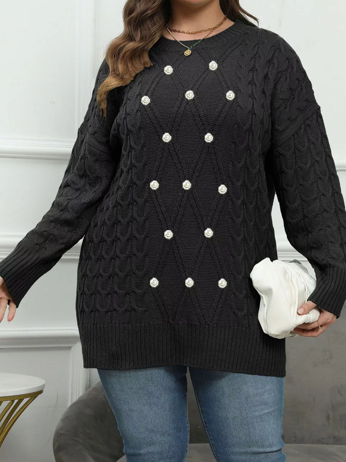 Black plus-size cable-knit sweater with pearl-like front accents, full front view