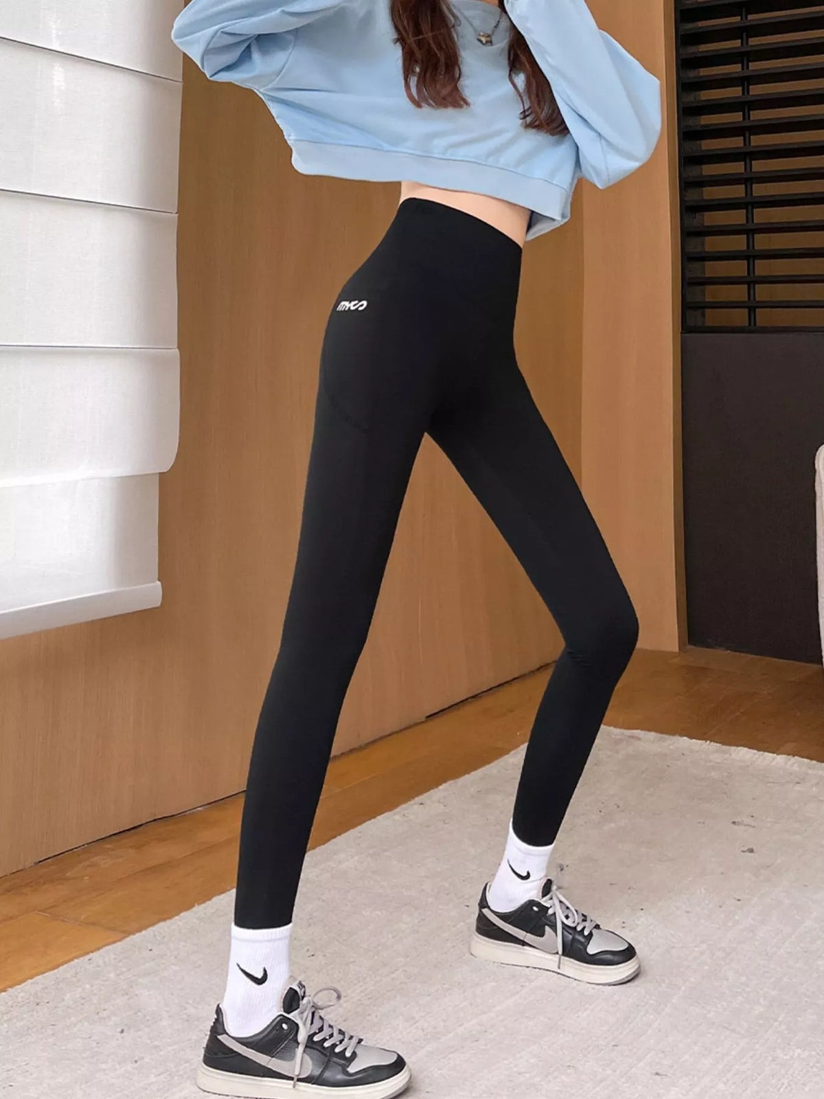 Women's High-Waisted Active Leggings with Side Pockets in black — side view