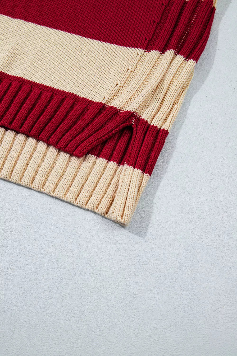 Striped High Neck Ribbed Trim Sweater in red and cream, hem detail