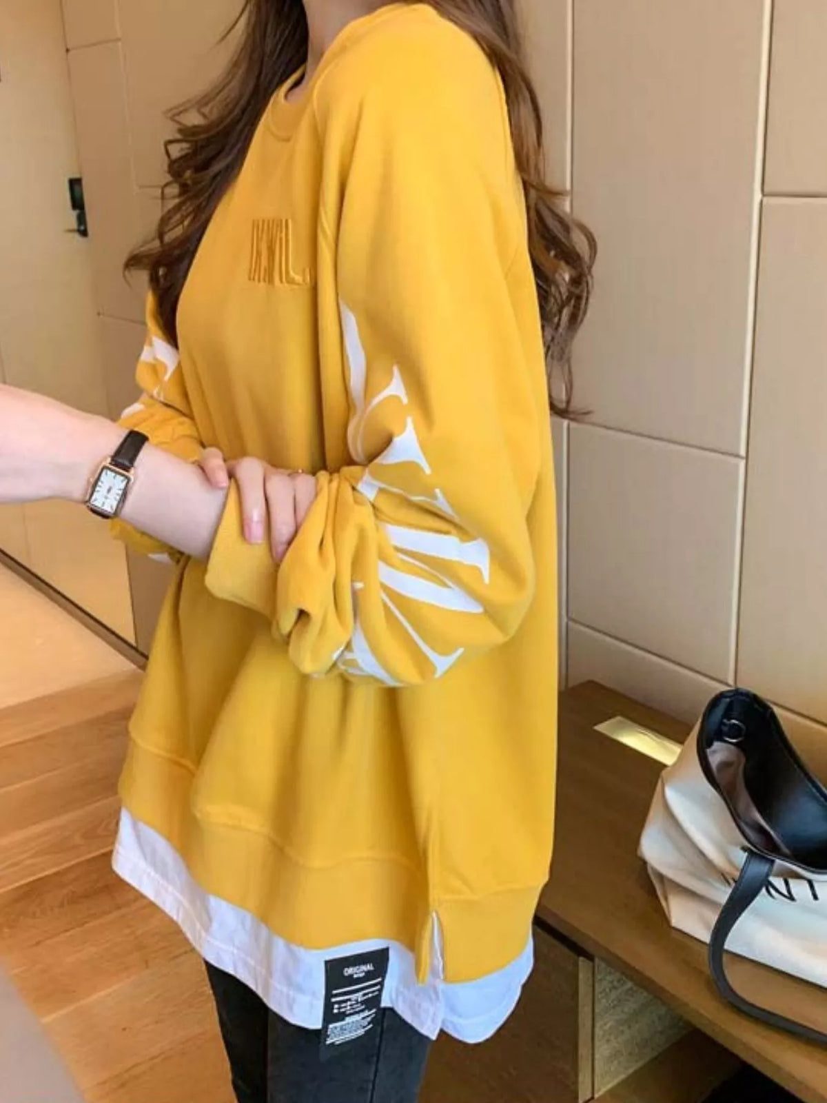 Yellow layered-hem sweatshirt with graphic sleeve detail