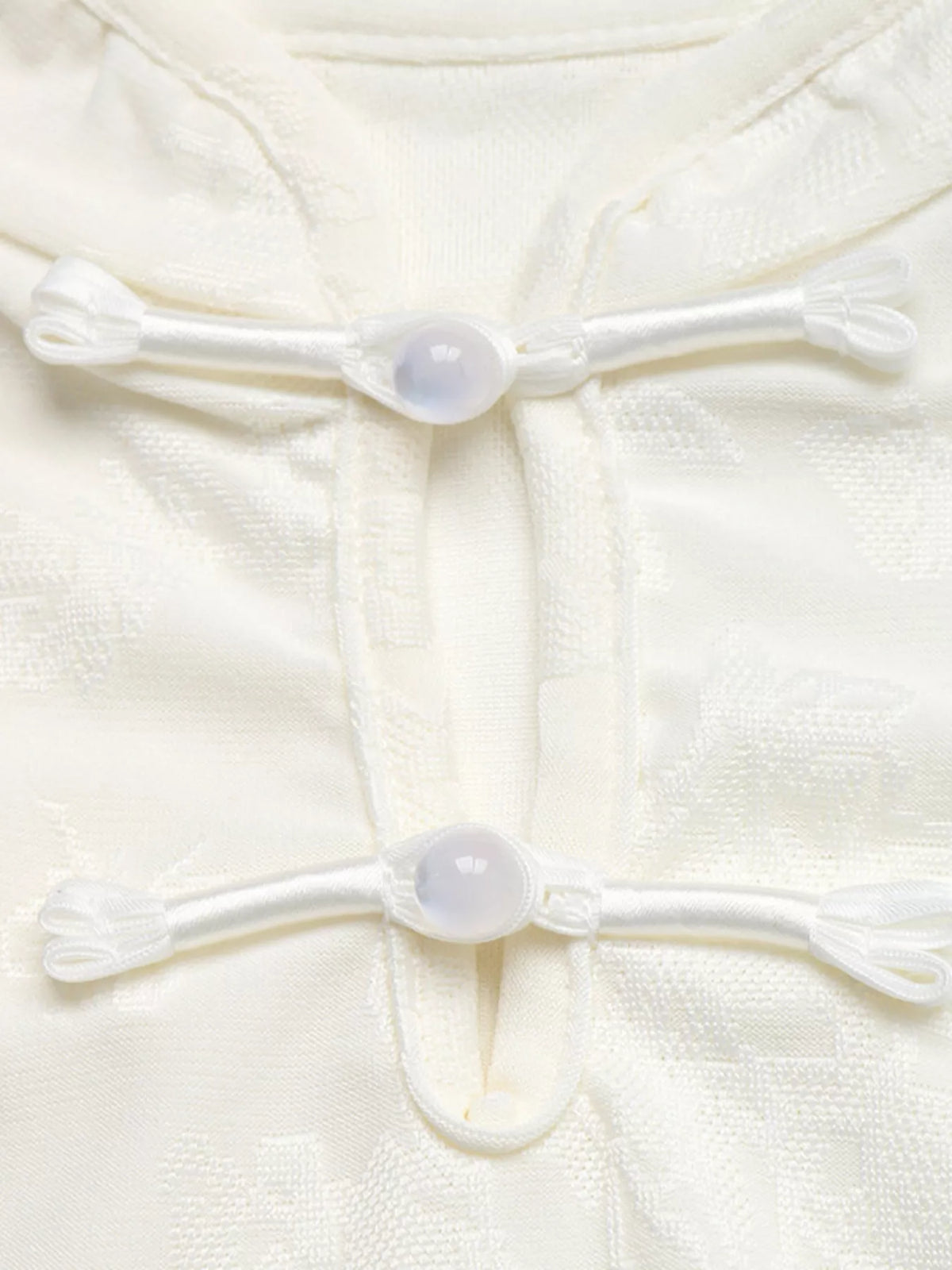 Ivory floral jacquard top with Mandarin collar and loop-button neckline, button detail