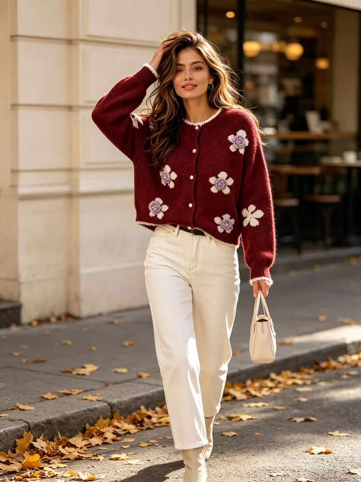 Floral-applique knit cardigan in burgundy, standing front view outside