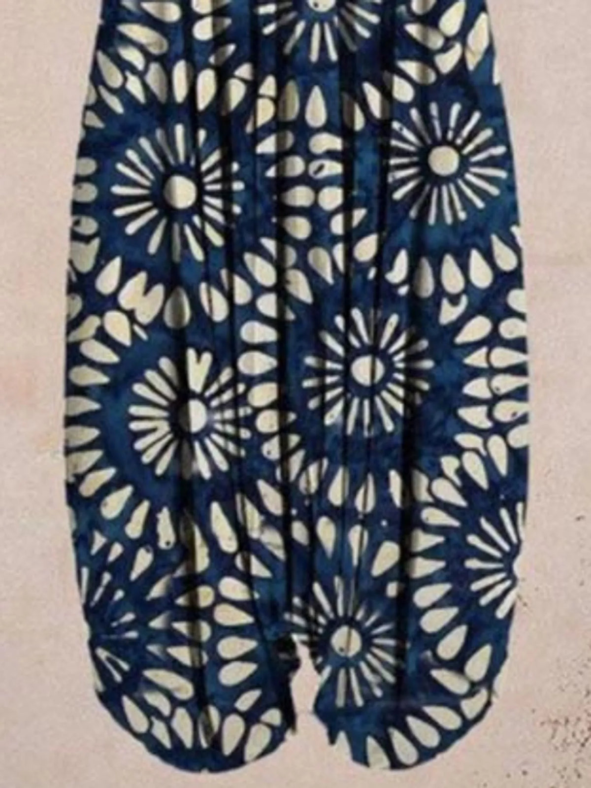 Navy and cream floral-print V-neck sleeveless jumpsuit, leg and print detail