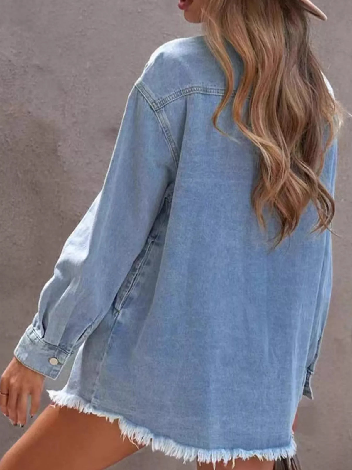 Women's Raw Hem Button Up Denim Jacket in light blue — back view