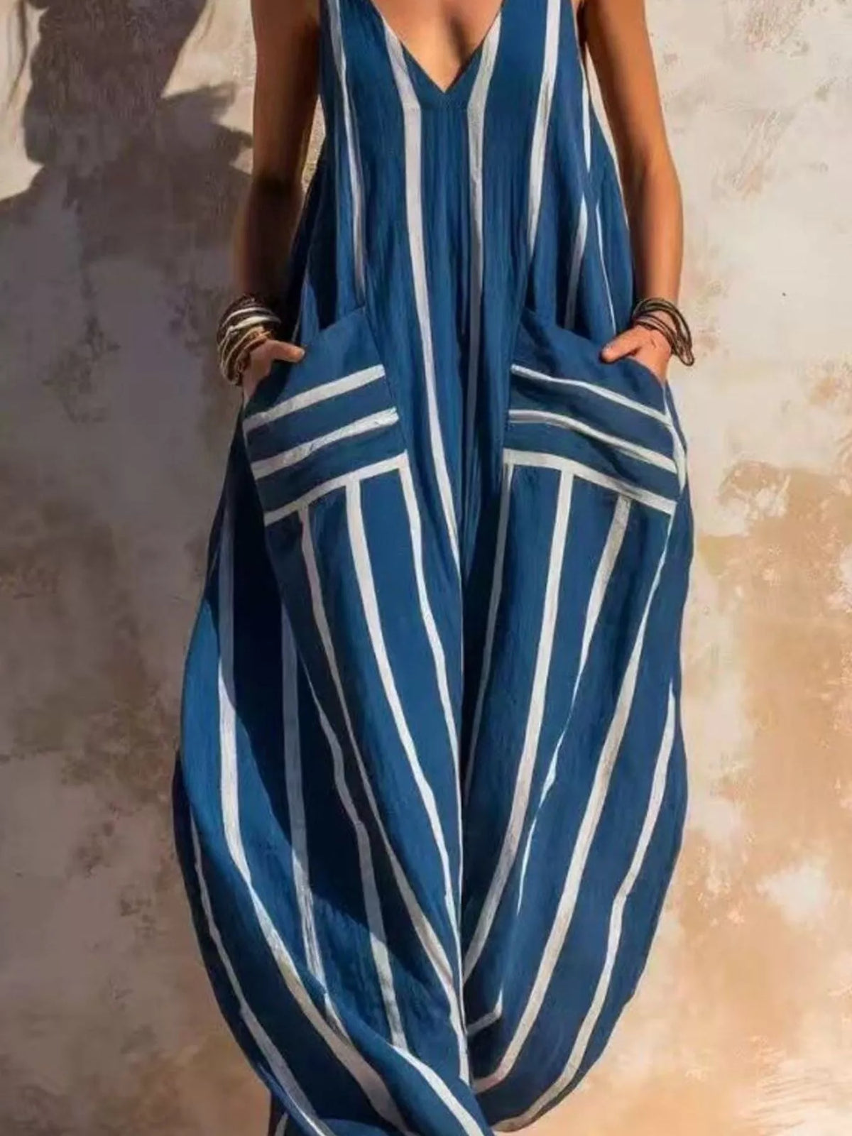Blue and white striped sleeveless jumpsuit, neckline and pockets detail