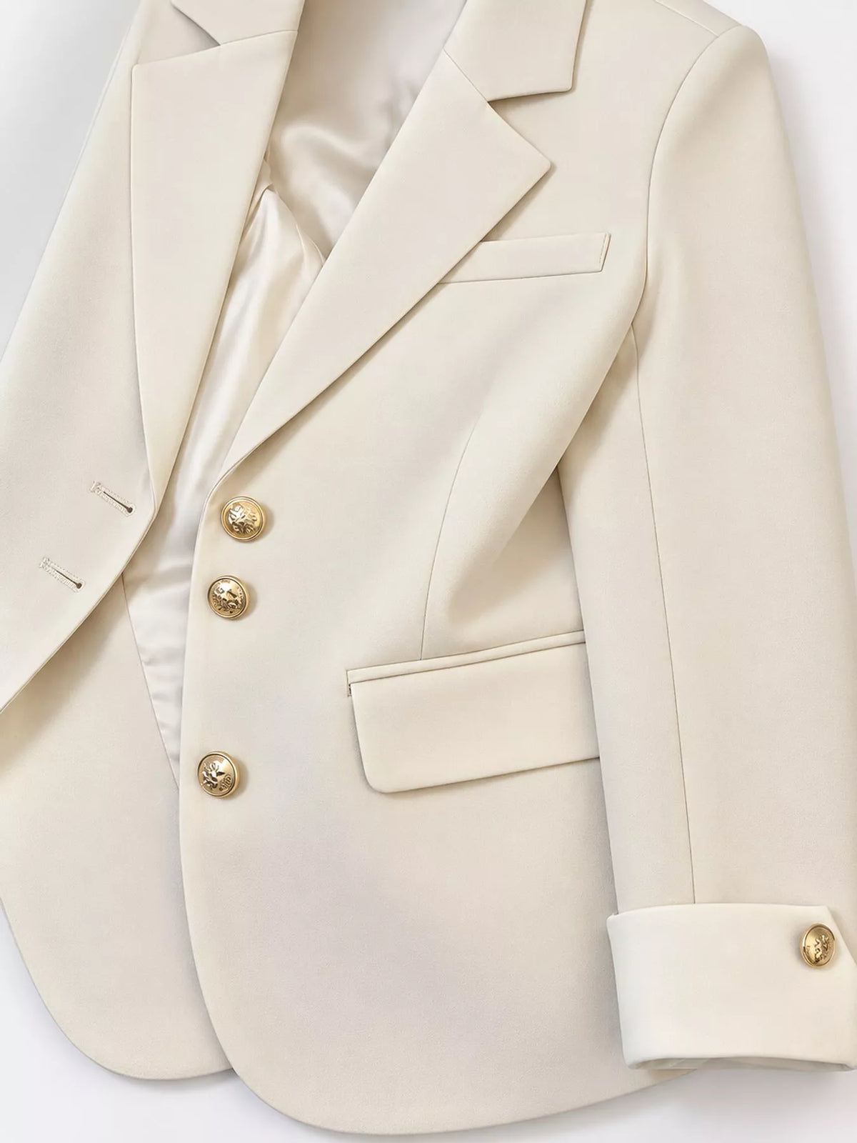 Cream single-breasted blazer with gold-tone buttons, lapel, gold-tone buttons, and contrast cuff