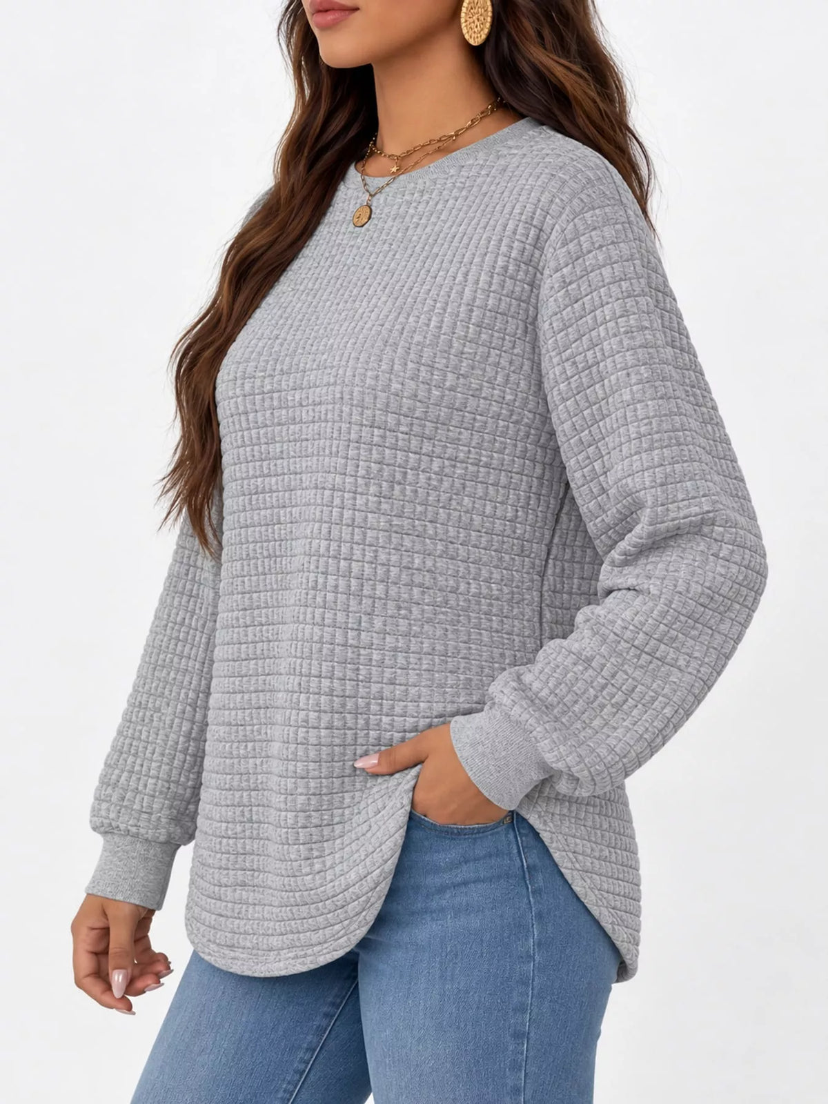 Gray waffle knit sweatshirt with curved hem, side view