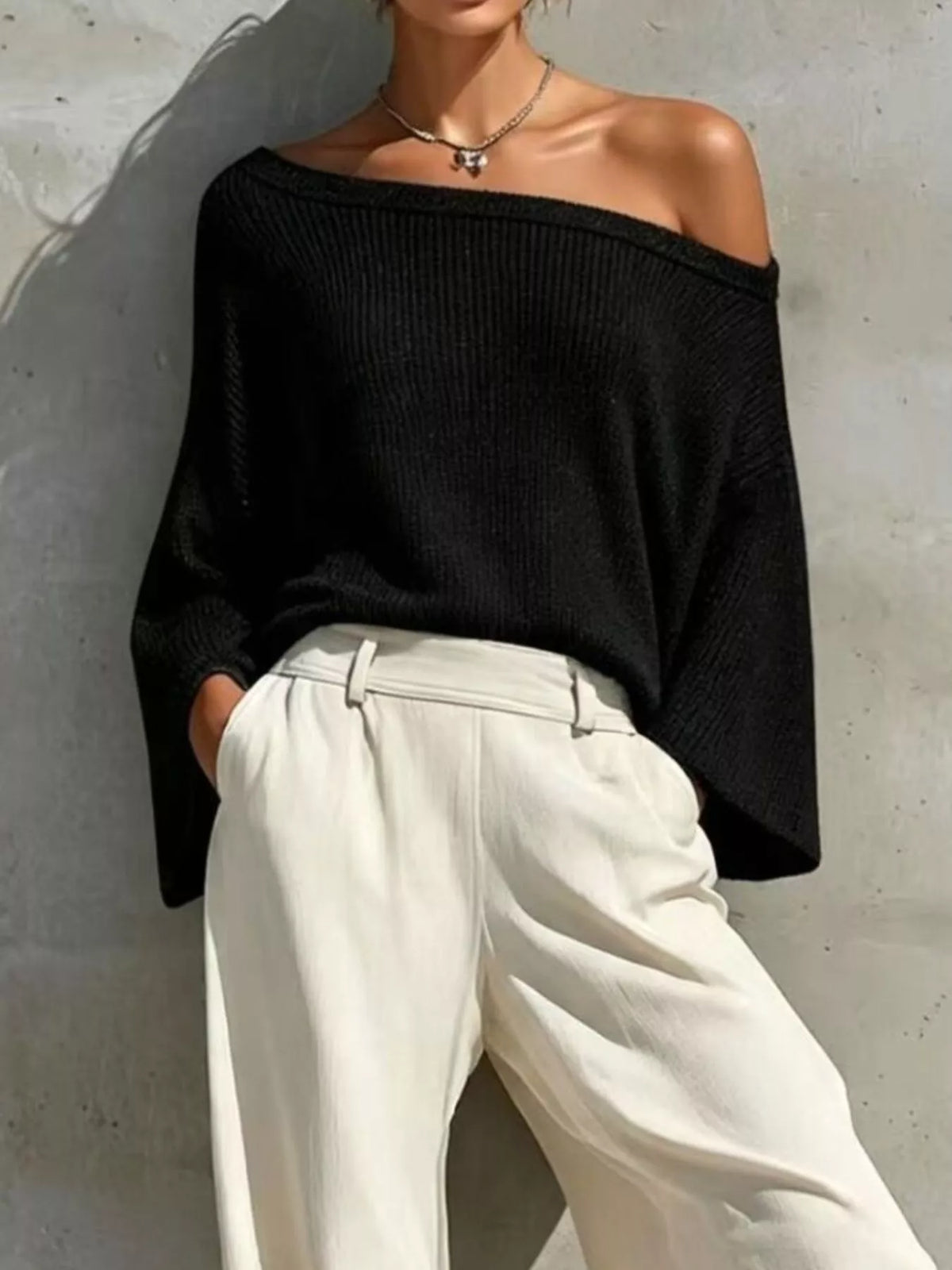 Black one-shoulder knit top and pants set, knit top neckline detail.