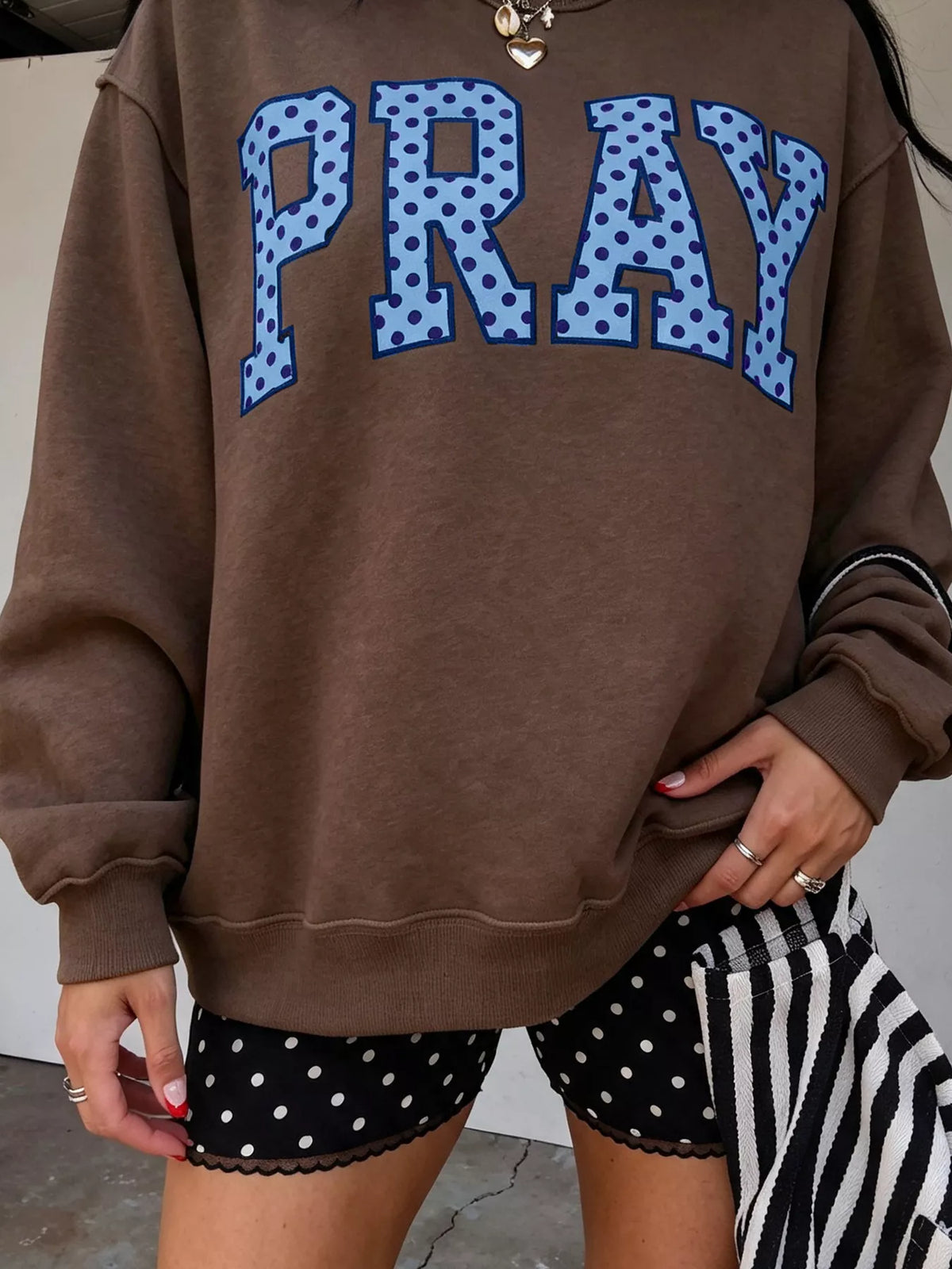 PRAY Polka Dot Embroidered Mock Neck Sweatshirt in dark brown, front view