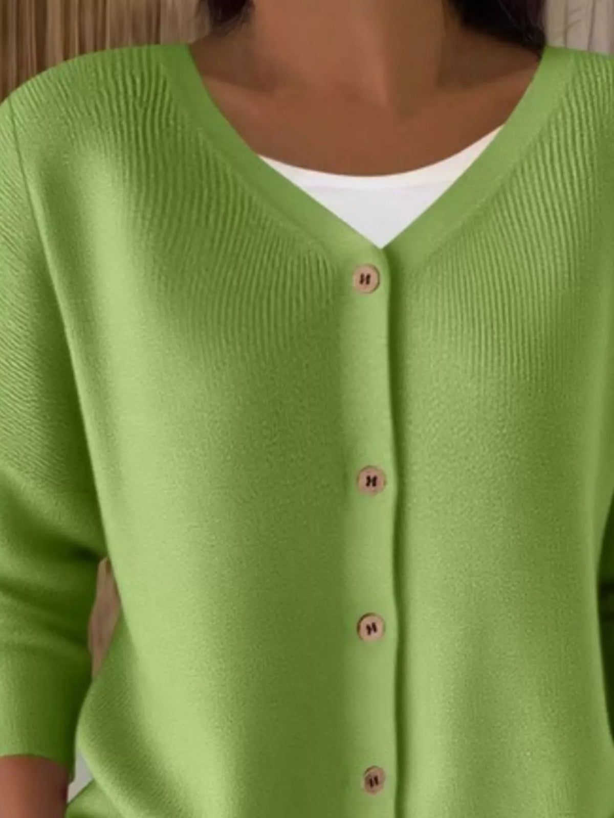 Green ribbed button-front cardigan, neckline close-up