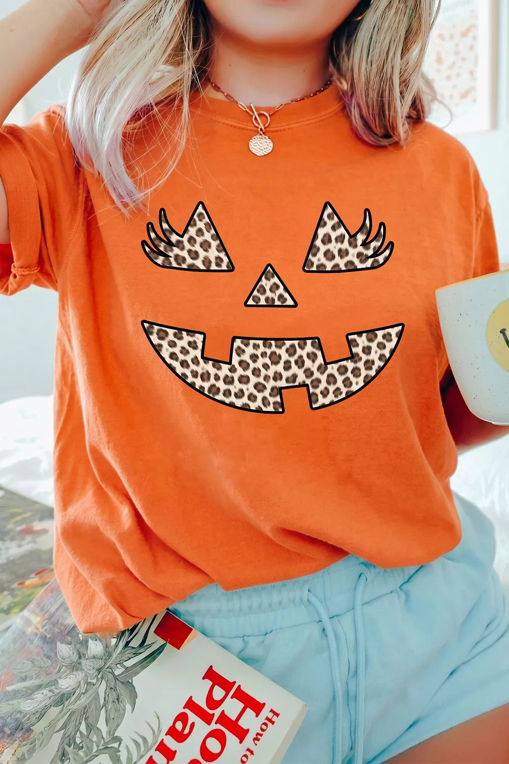 Women's Halloween Pumpkin Face Leopard Graphic T-Shirt in Orange, back view