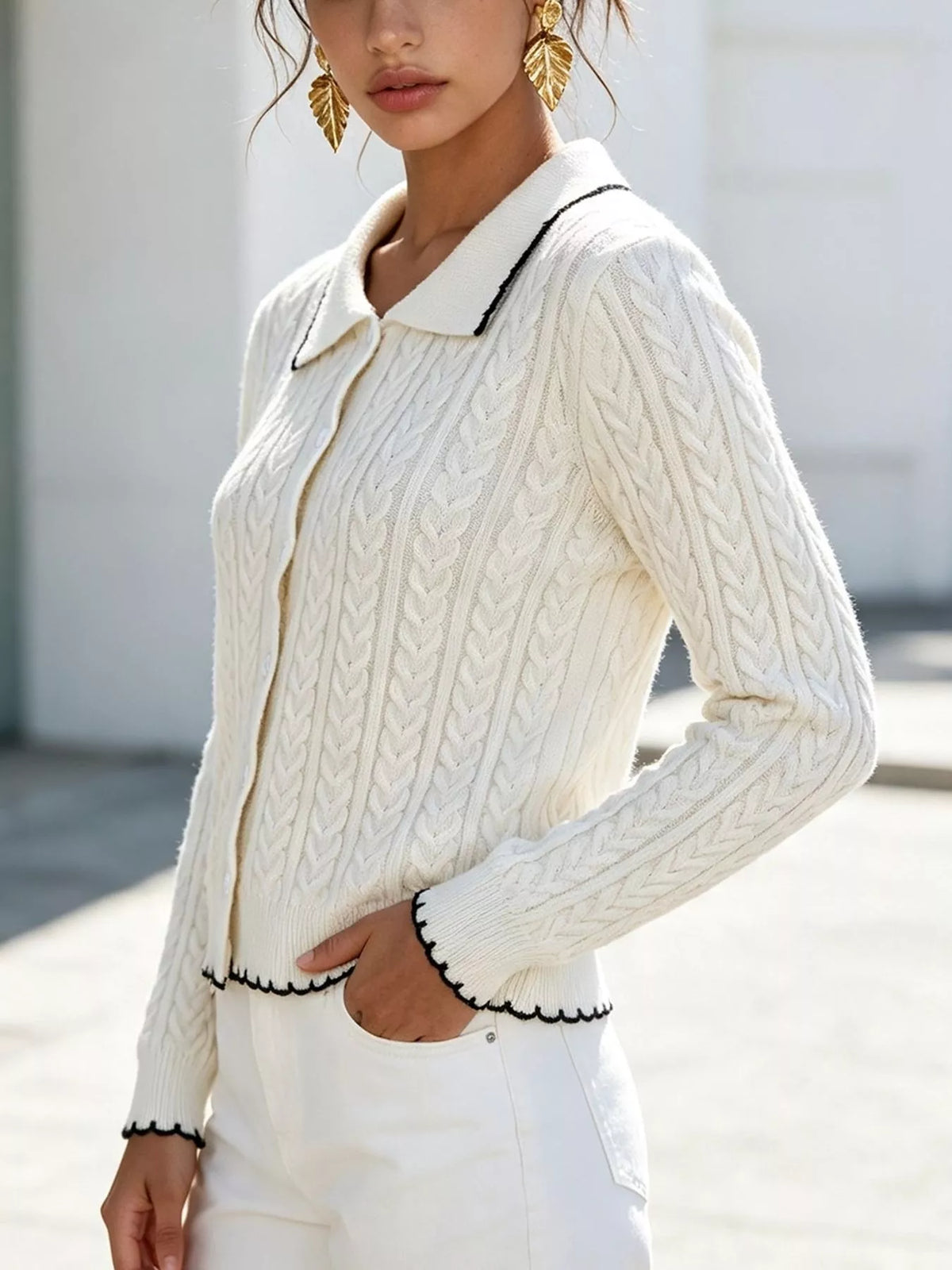 Ivory cable-knit polo-collar cardigan, cable knit front detail.