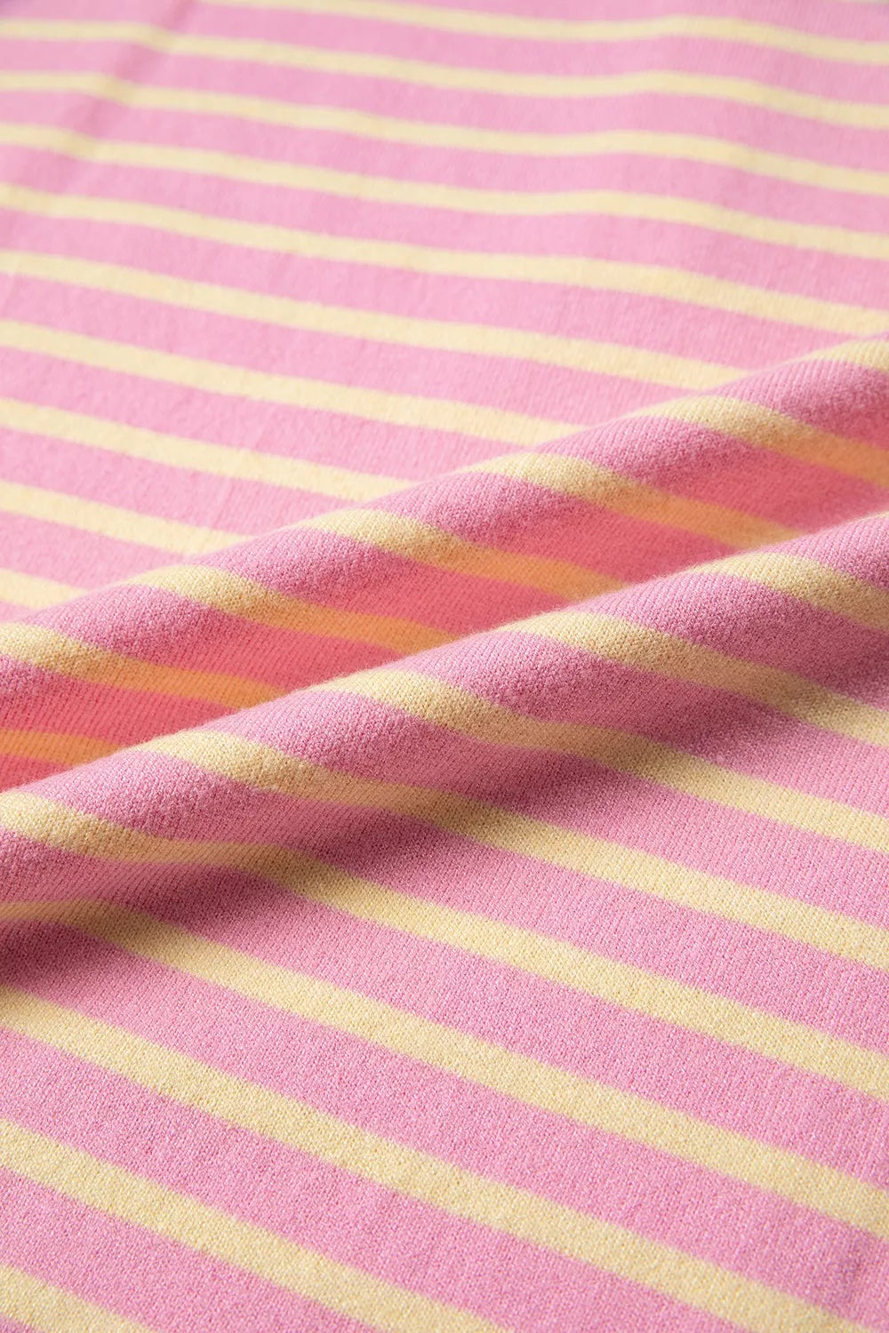 Pink and yellow striped button-detail sweater, fabric close-up