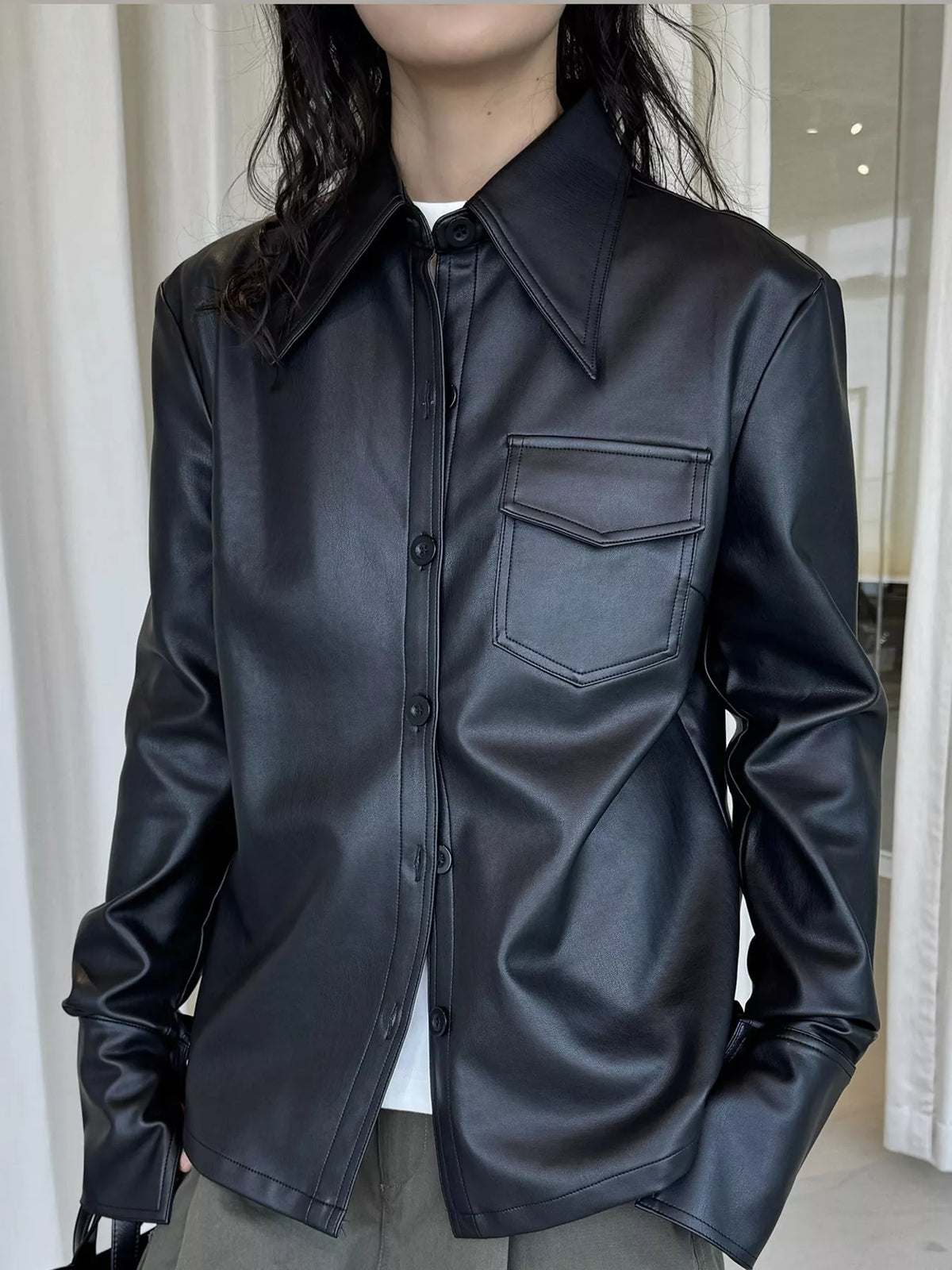 Black faux leather button-front jacket — front view