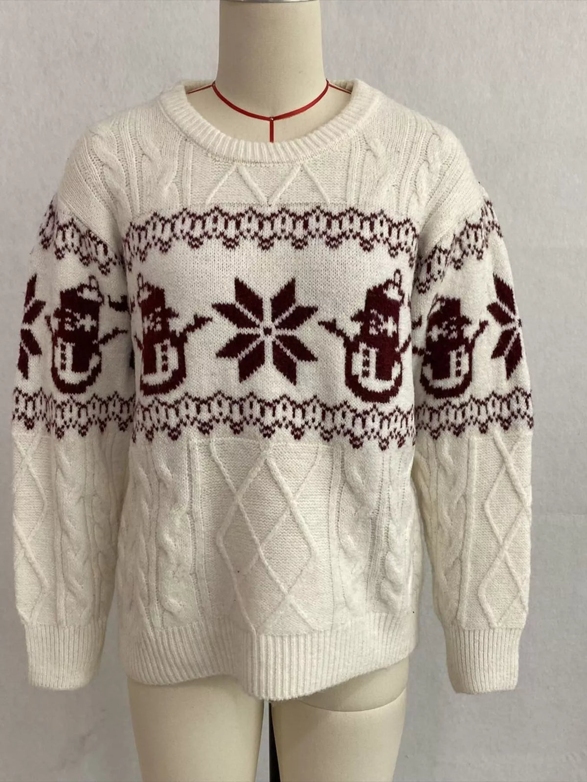 Ivory christmas snowman cable-knit sweater, front on dress form.