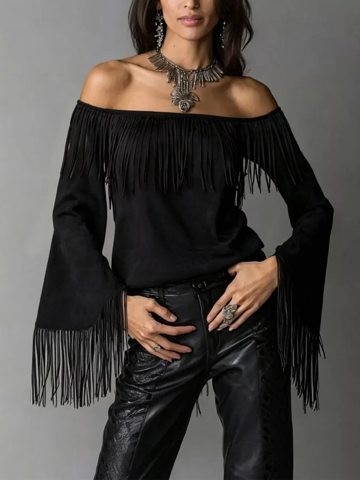 Off-shoulder faux suede fringe top in black, front view