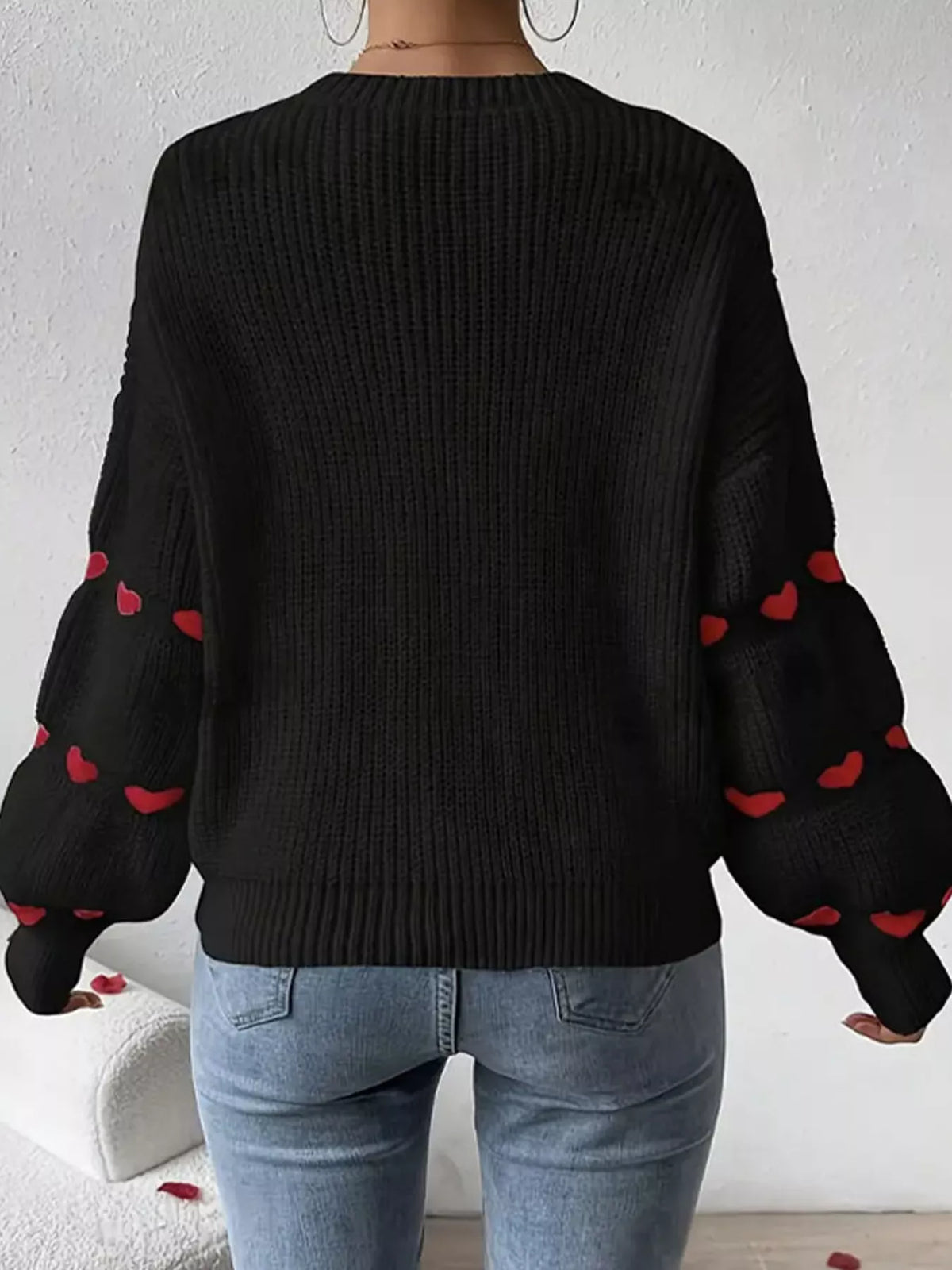 Black and red heart-sleeve dropped-shoulder sweater, back view.