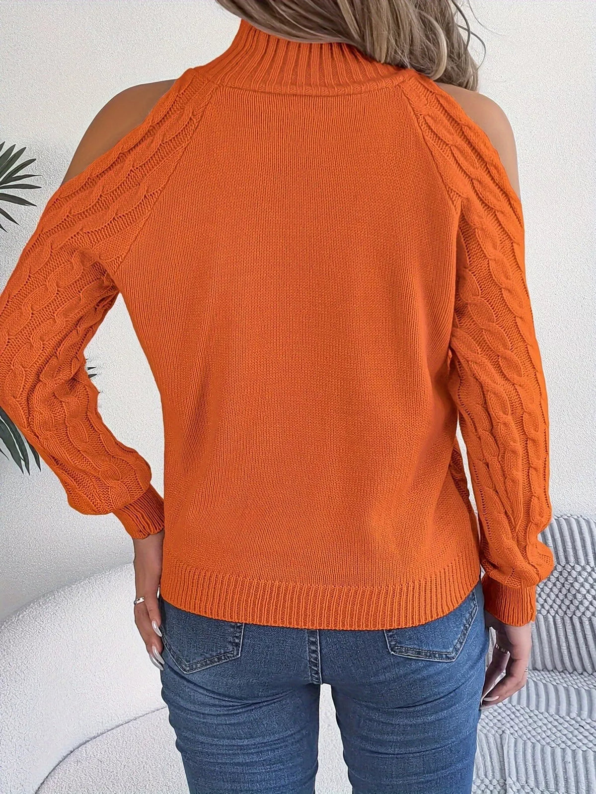 Orange cold-shoulder cable-knit sweater, back view.