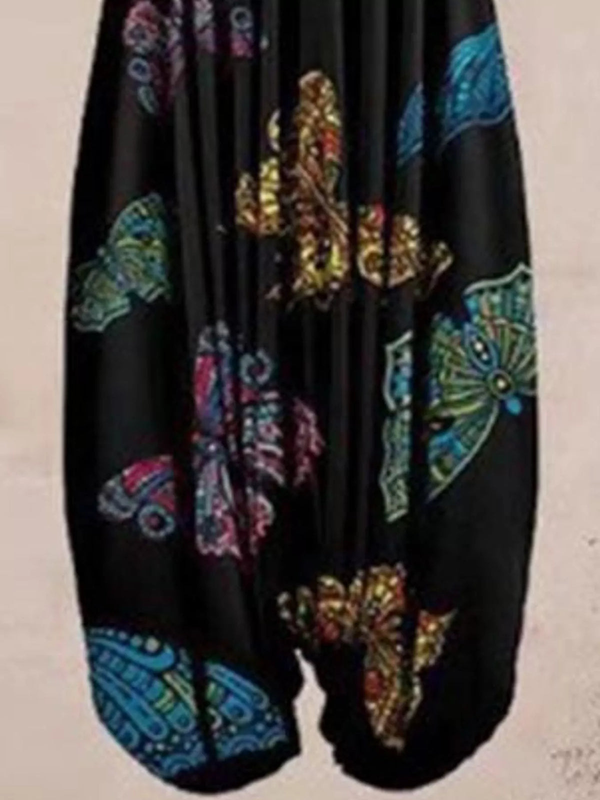 Black butterfly-print V-neck sleeveless jumpsuit, leg and print detail