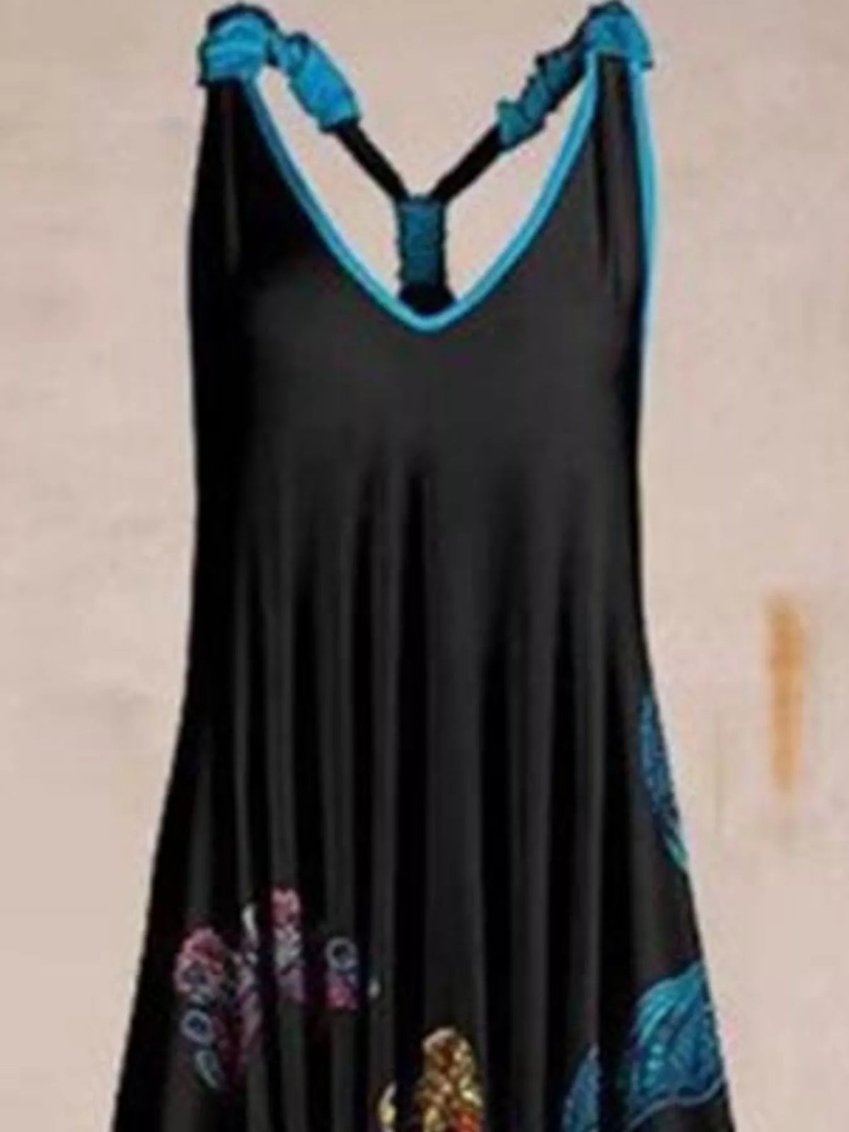 Black butterfly-print V-neck sleeveless jumpsuit, neckline and strap detail