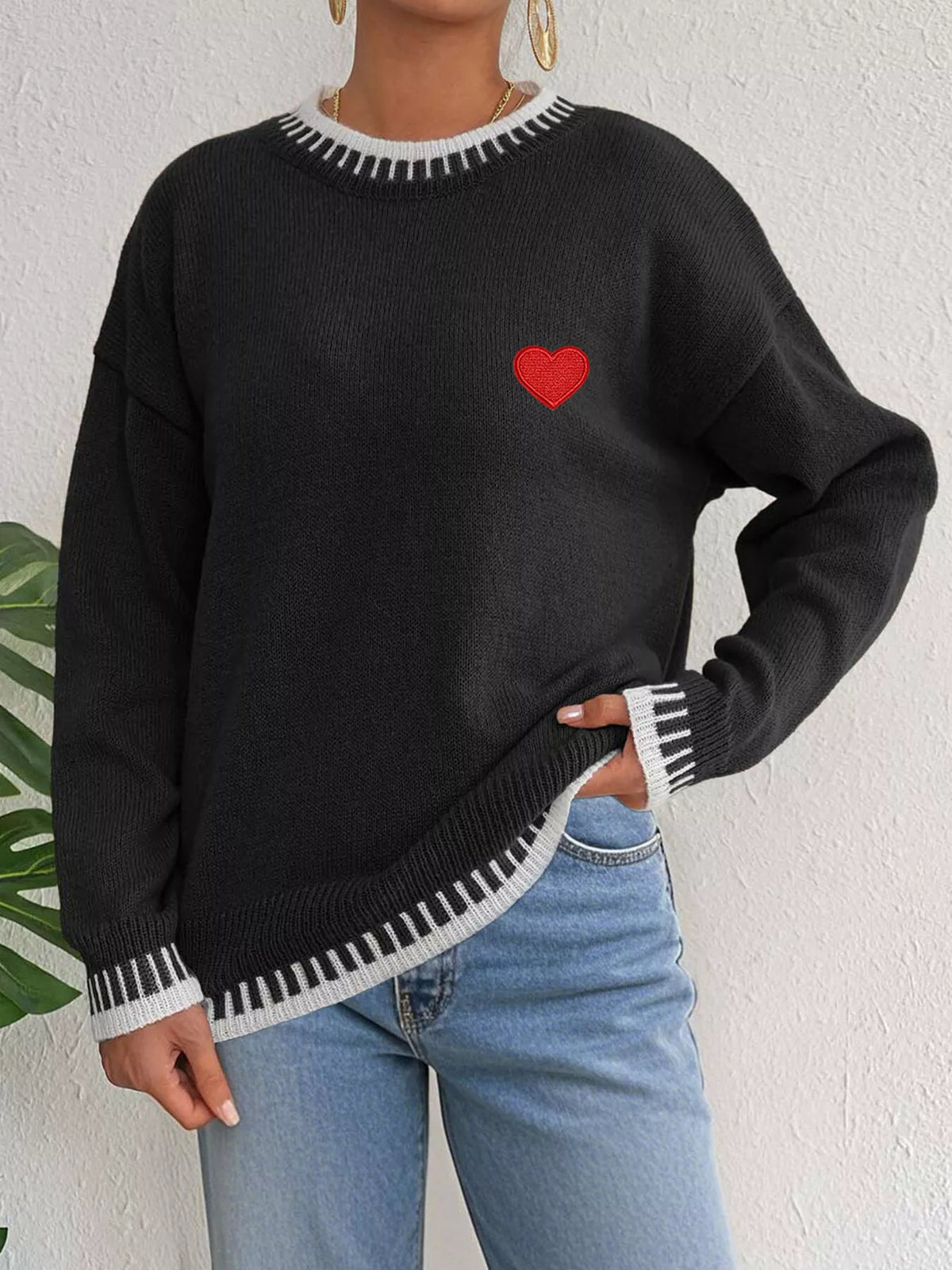 Heart-embroidered contrast-trim sweater in black, angled front view