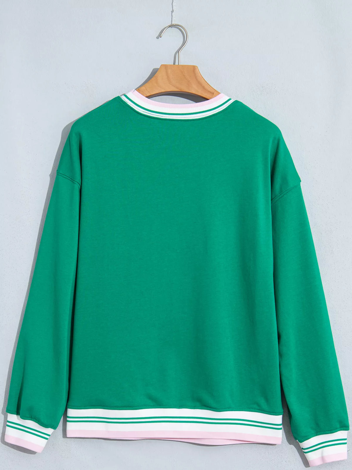 Green sweatshirt with contrast striped ribbed trim, back view