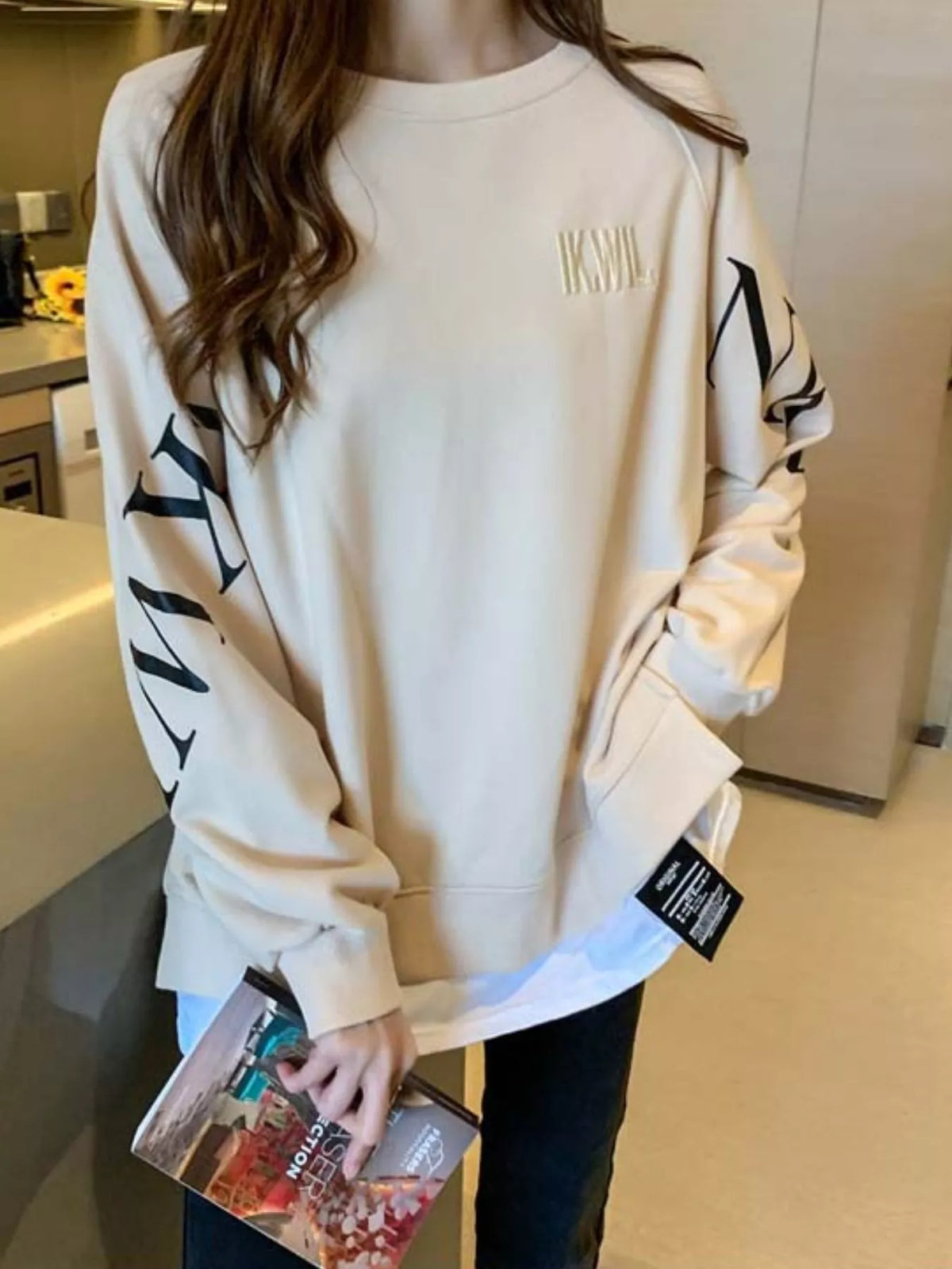 Apricot layered-hem sweatshirt with graphic sleeve detail