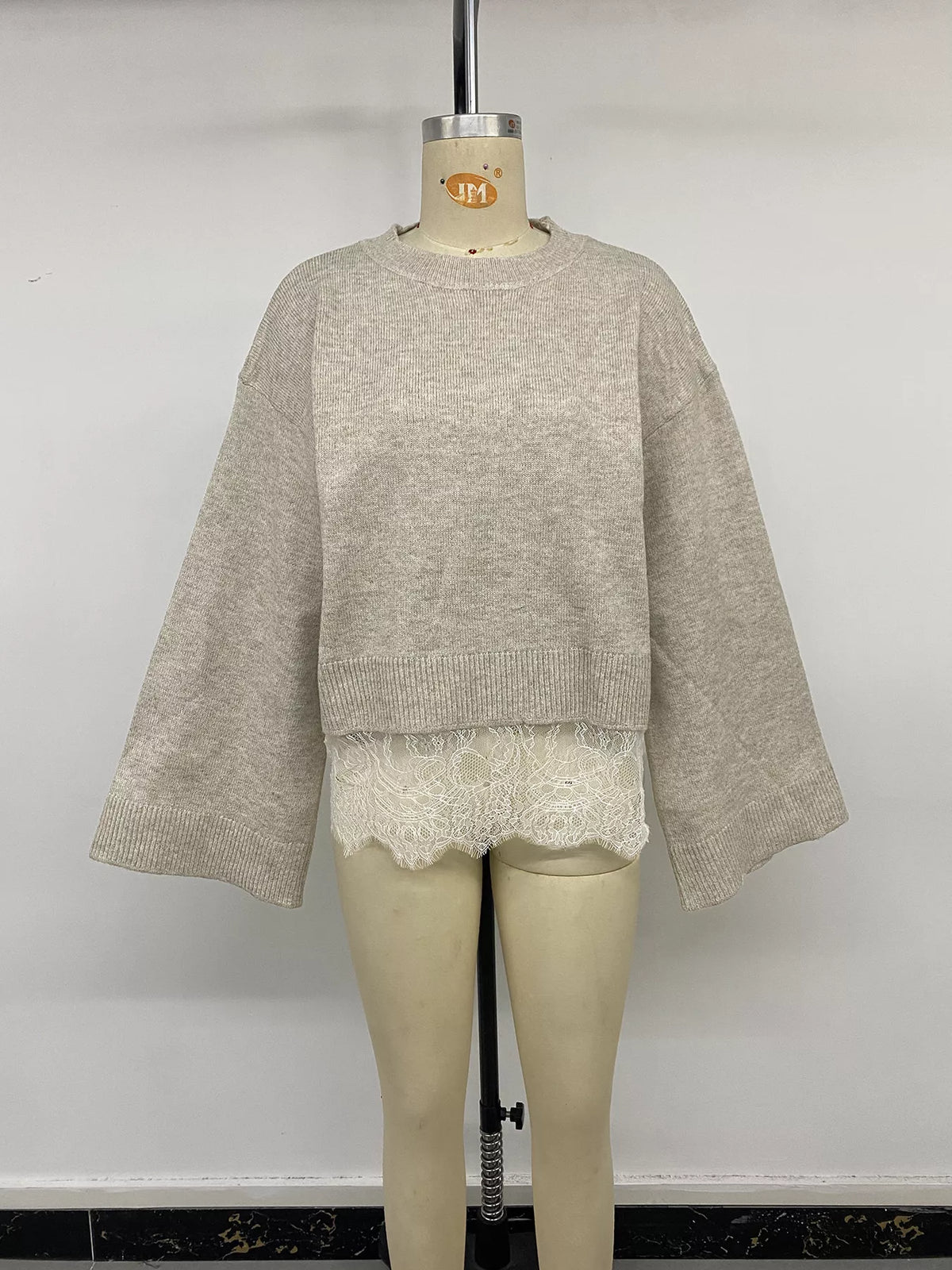 Beige layered lace hem sweater, front on mannequin
