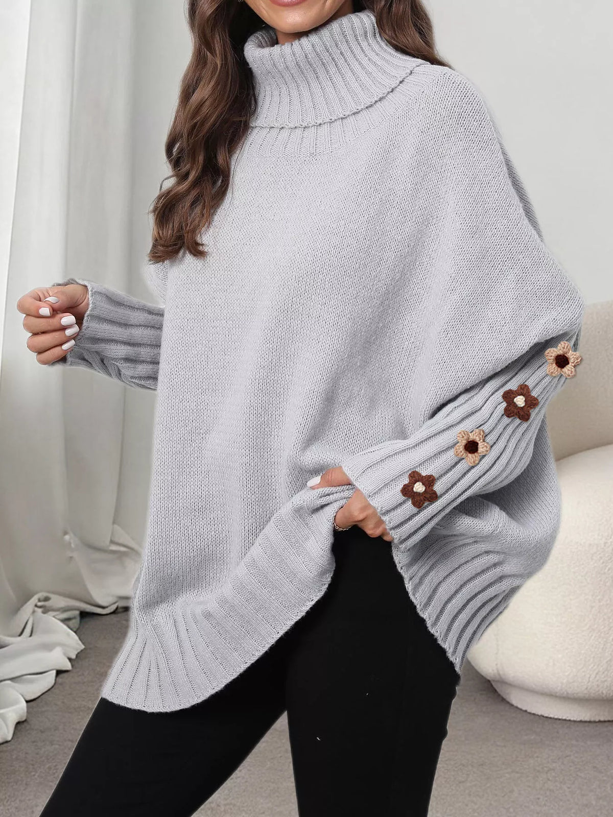 Gray oversized floral sleeve turtleneck sweater, sleeve and hem view