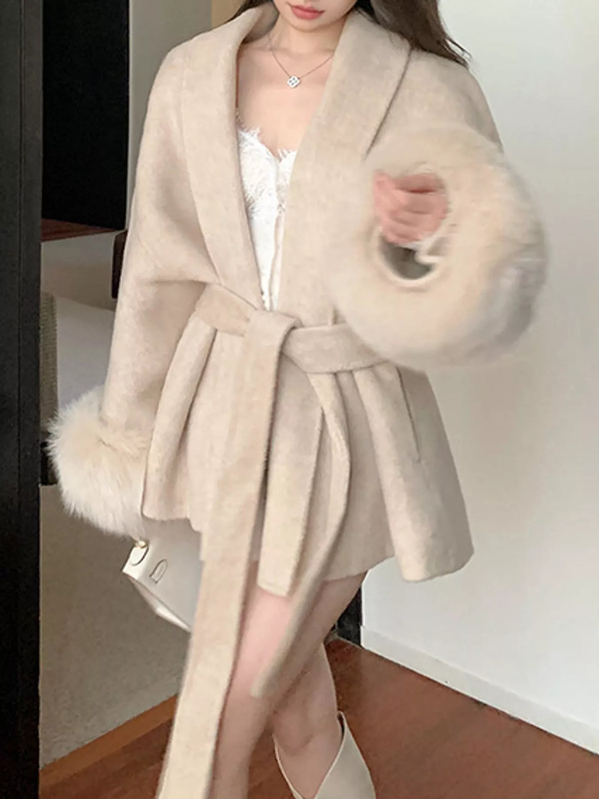 Cream tie-waist coat with faux fur cuffs — front view