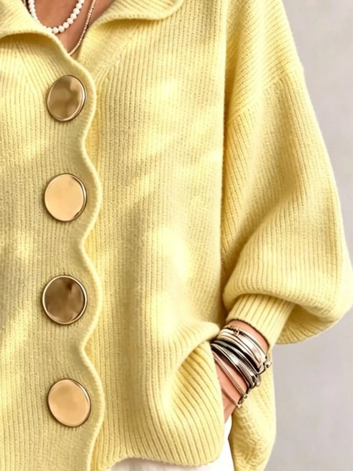 Pastel yellow scalloped-edge knit cardigan, button and cuff detail
