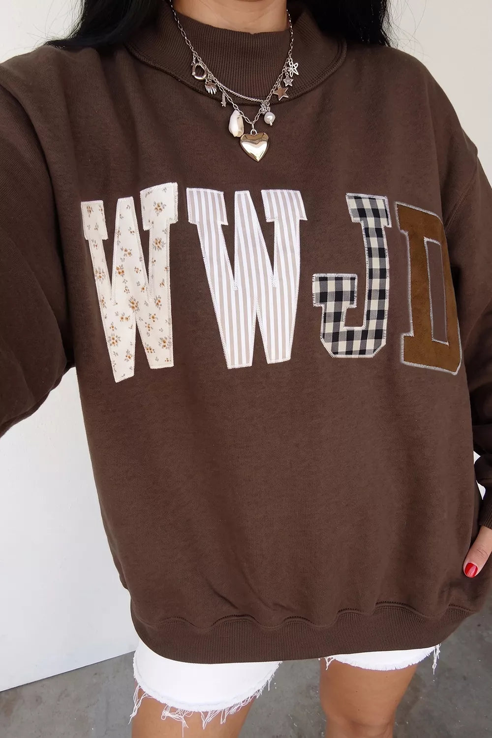 Brown wwjd patchwork graphic mock-neck sweatshirt, WWJD graphic front view.