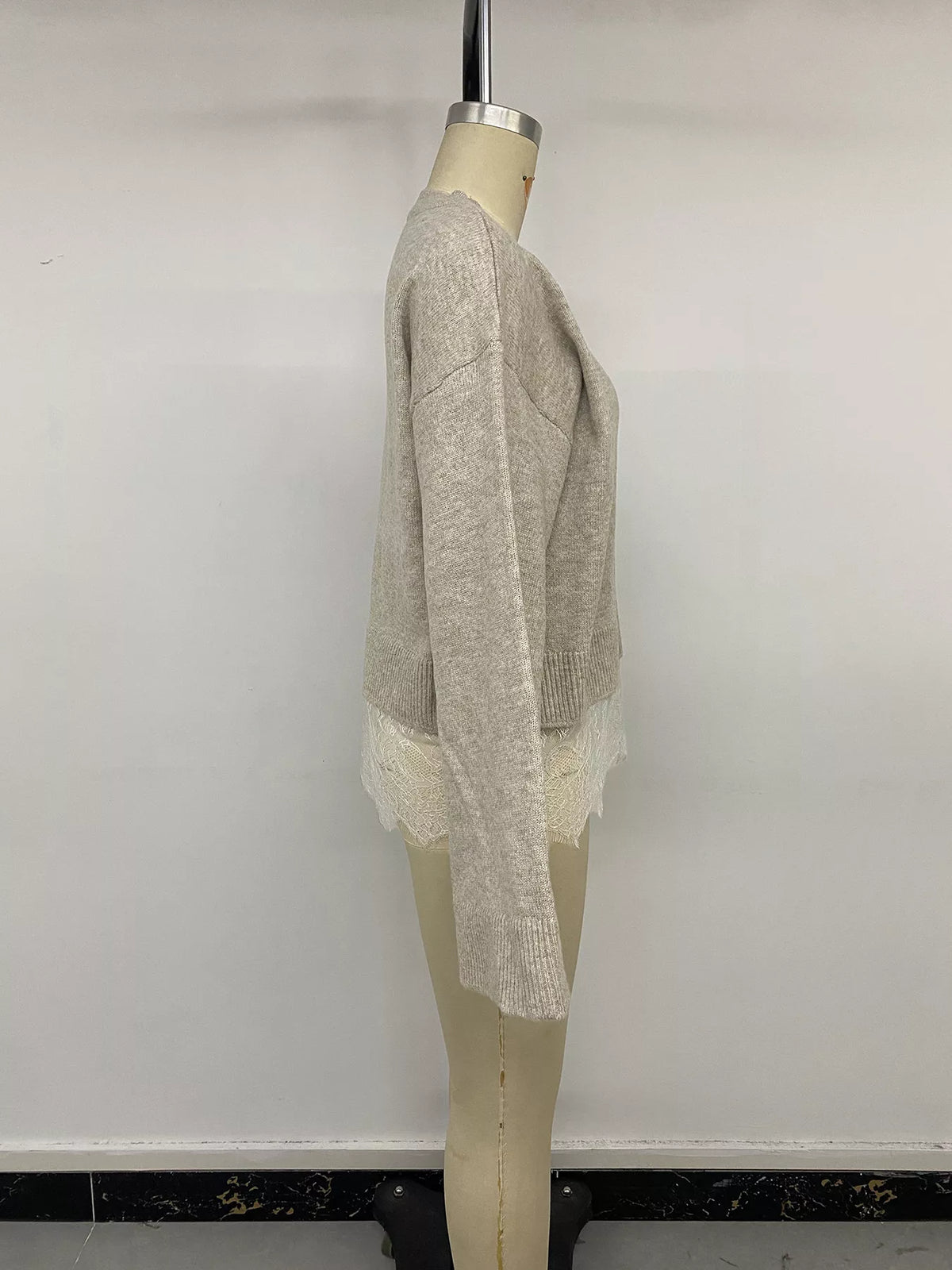Beige layered lace hem sweater, side on mannequin