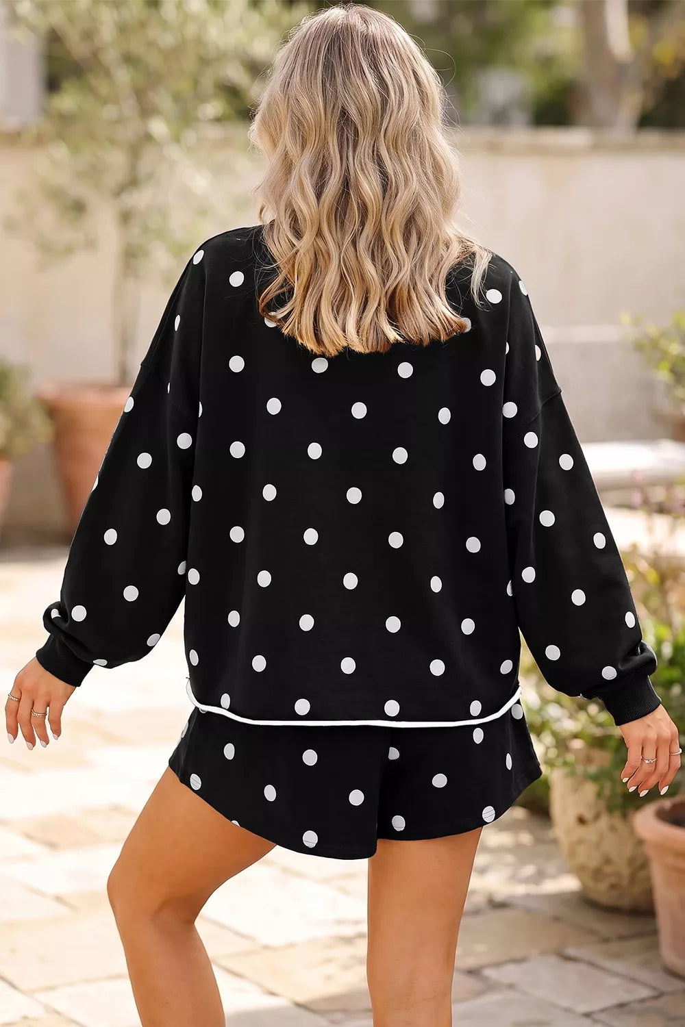 Polka Dot Raw Hem Pullover and Skort Set in black, back view