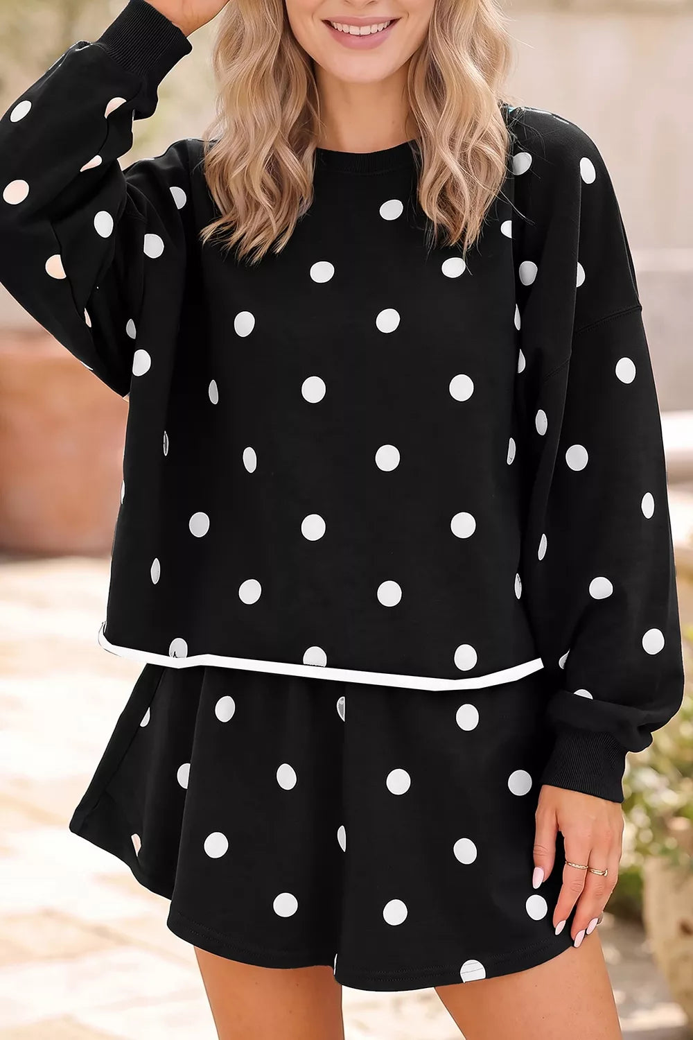 Polka Dot Raw Hem Pullover and Skort Set in black, front view